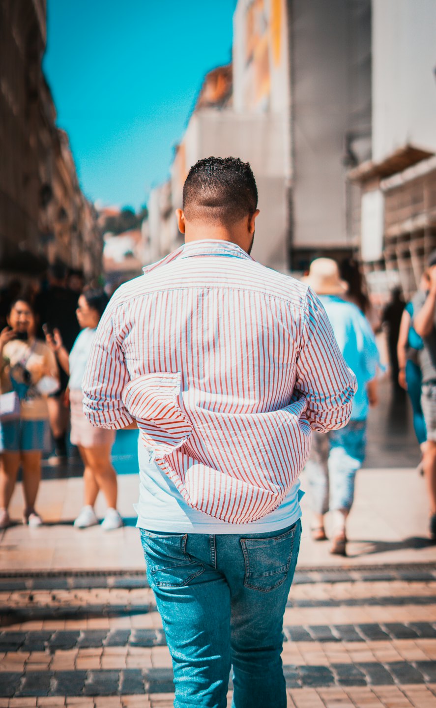 A man walks down a busy city street.